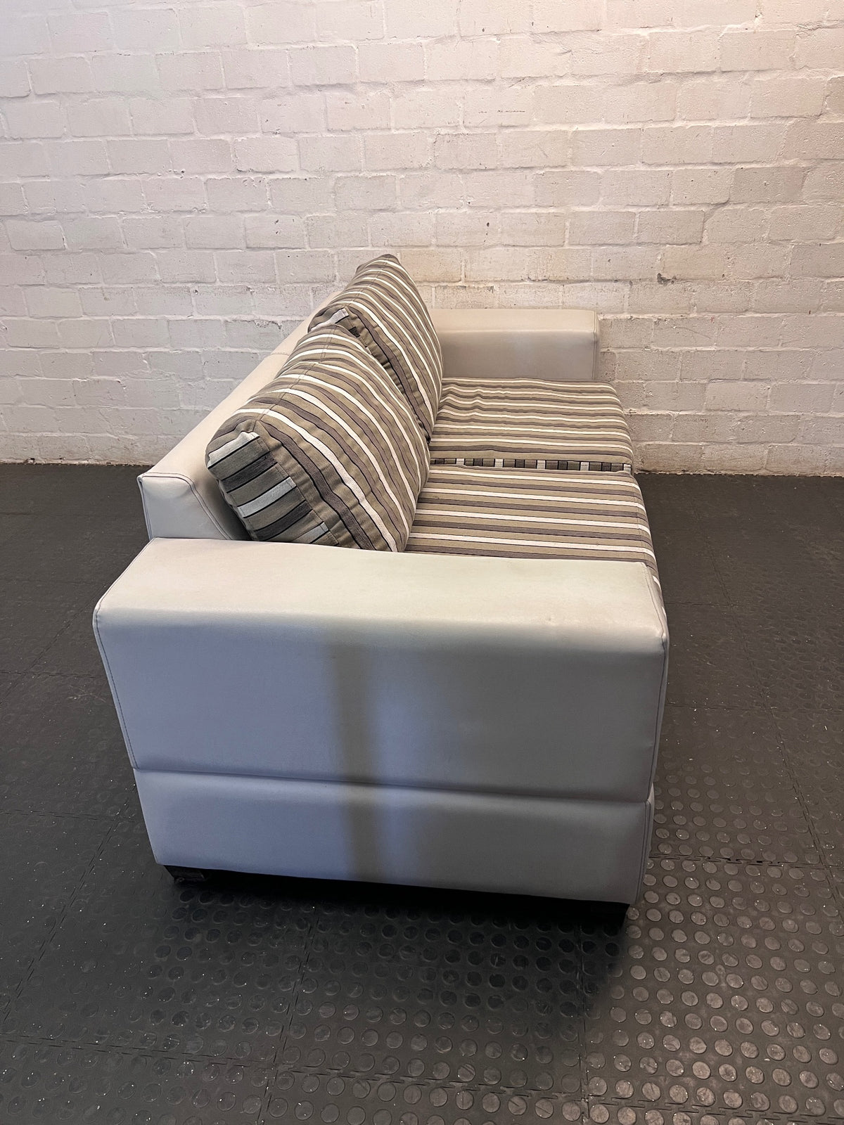 White Two Seater Couch with Striped Fabric Cushions – back view