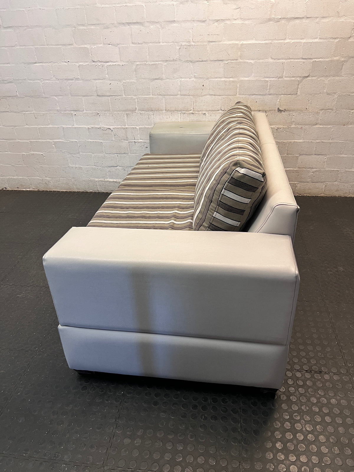 White Two Seater Couch with Striped Fabric Cushions – side view
