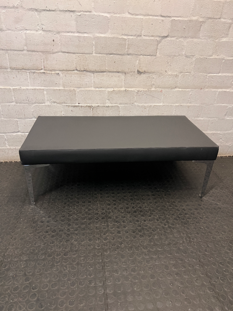 Black Upholstered Bench with Chrome Legs — Fair Condition with Visible Wear