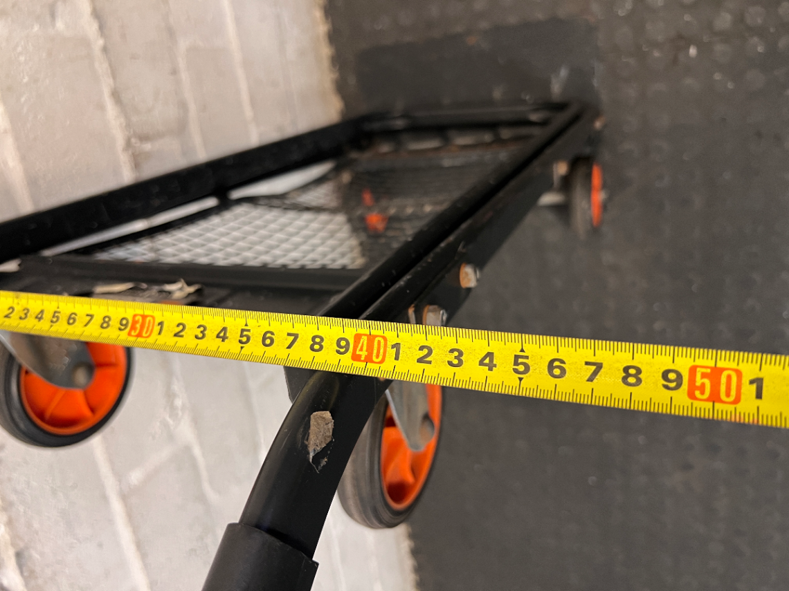 Black Metal Platform Trolley with Mesh Base — Fair Used Condition with Visible Wear