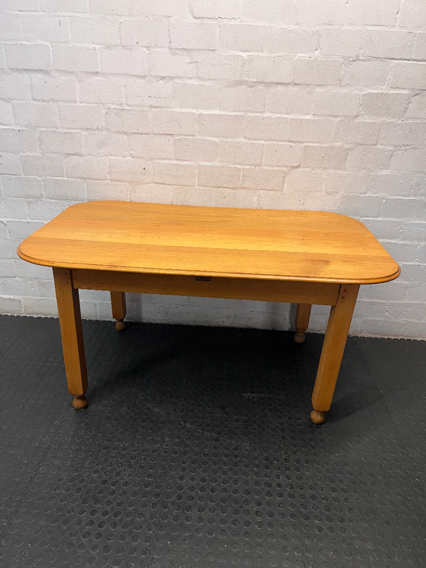 Wooden Dining Table with Rounded Corners and Bun Feet — Well Used with Scratches and Fading on Seats