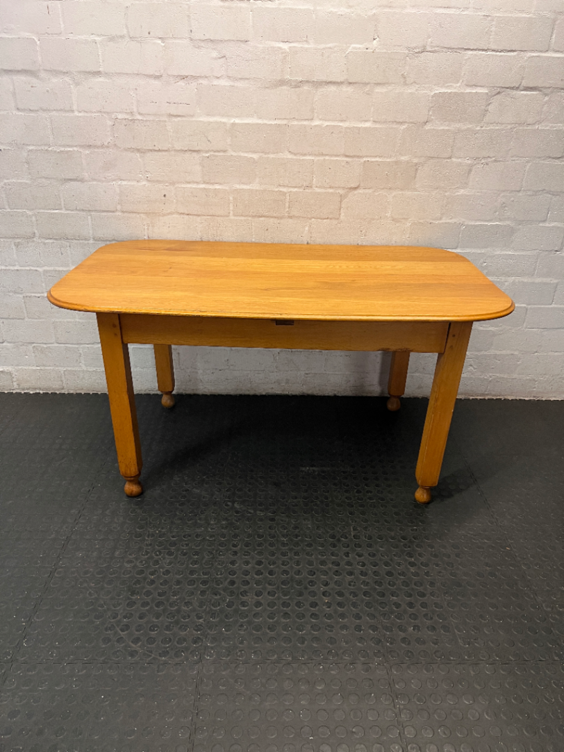 Wooden Dining Table with Rounded Corners and Bun Feet — Well Used with Scratches and Fading on Seats