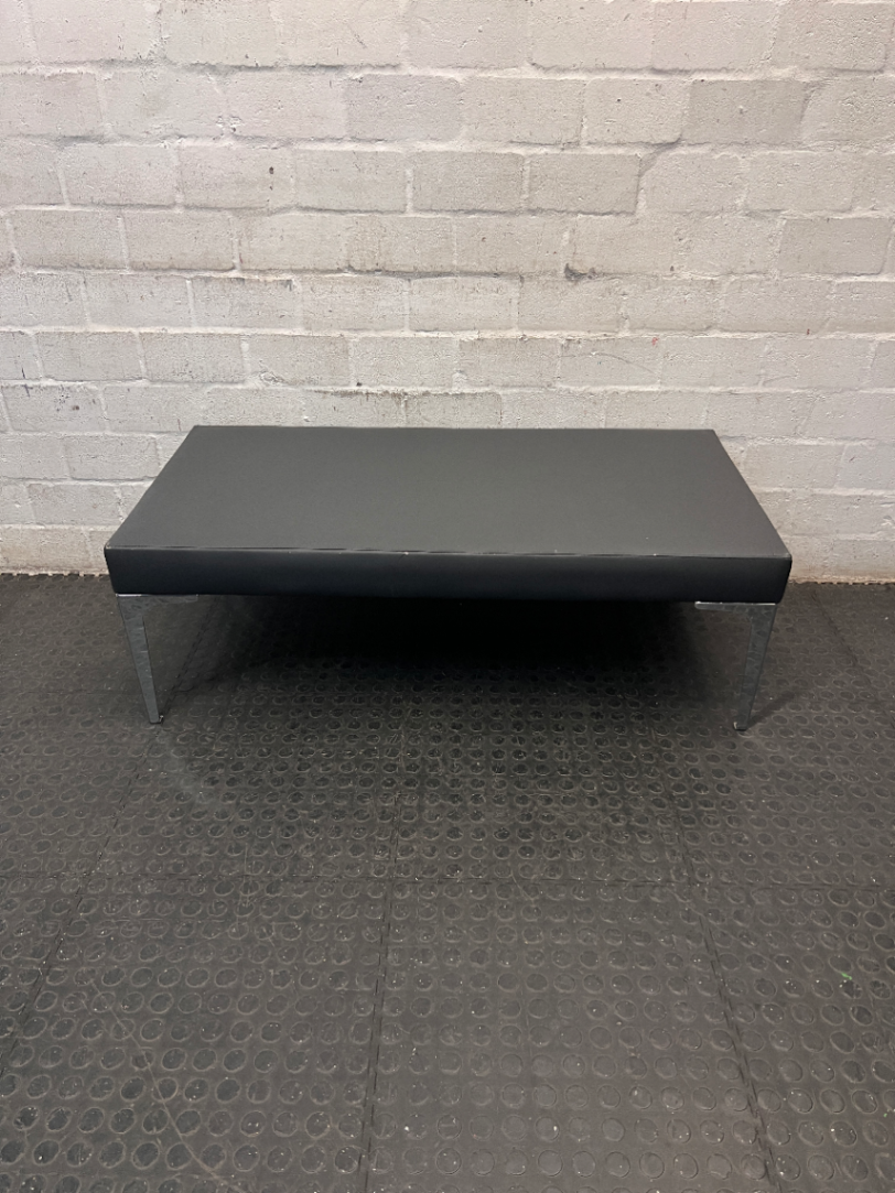 Black Upholstered Bench with Chrome Legs — Fair Condition with Visible Wear