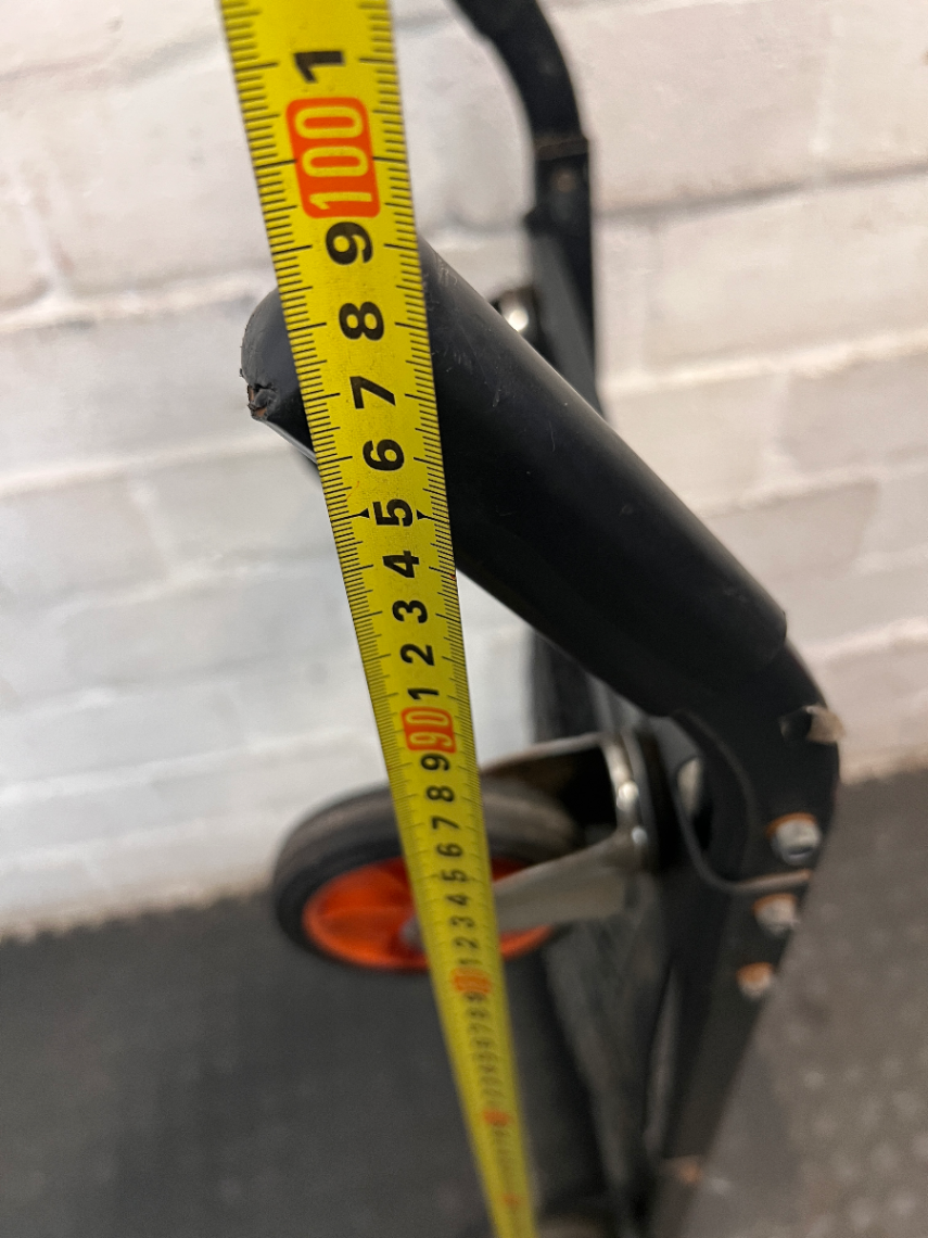 Black Metal Platform Trolley with Mesh Base — Fair Used Condition with Visible Wear