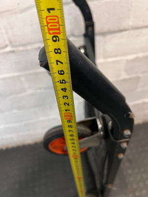 Black Metal Platform Trolley with Mesh Base — Fair Used Condition with Visible Wear