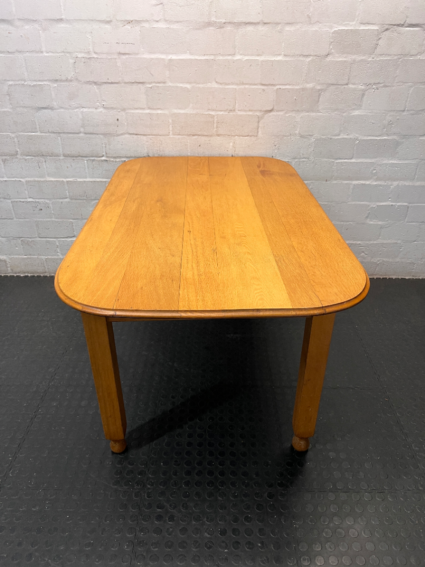 Wooden Dining Table with Rounded Corners and Bun Feet — Well Used with Scratches and Fading on Seats