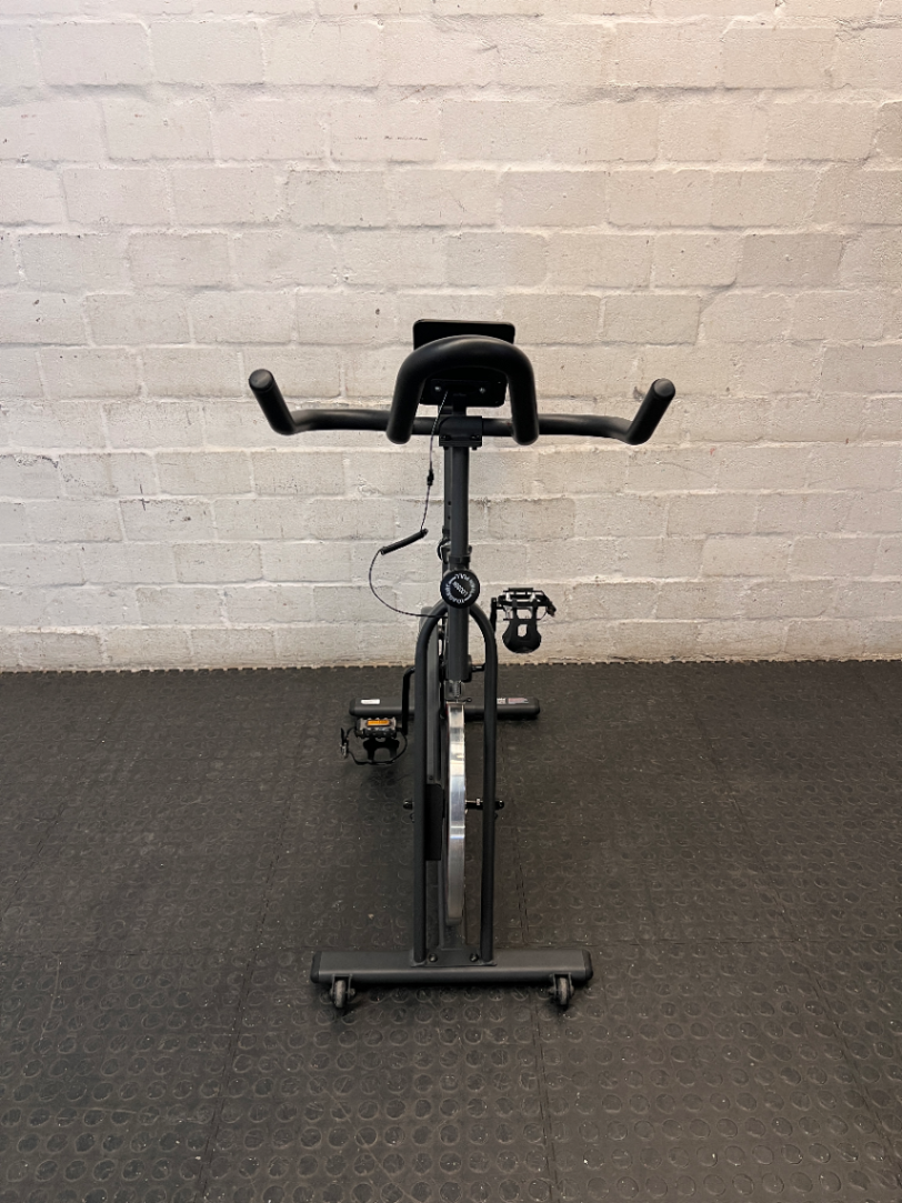 Trojan Spin 120 Exercise Bike in Dark Grey — Good Working Order; Missing Sticker on Wheel