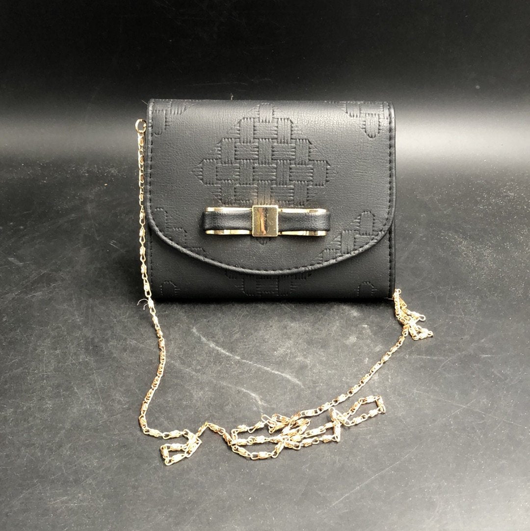 Black small handbag with a gold chain